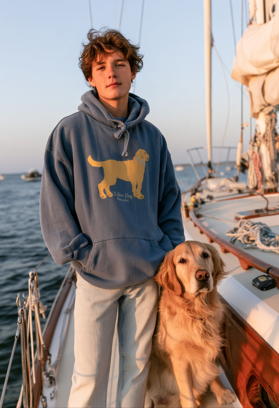 Teenage boy on a sailboat off Nantucket wearing a Washed Denim Blue Yellow Dog pullover hooded sweatshirt